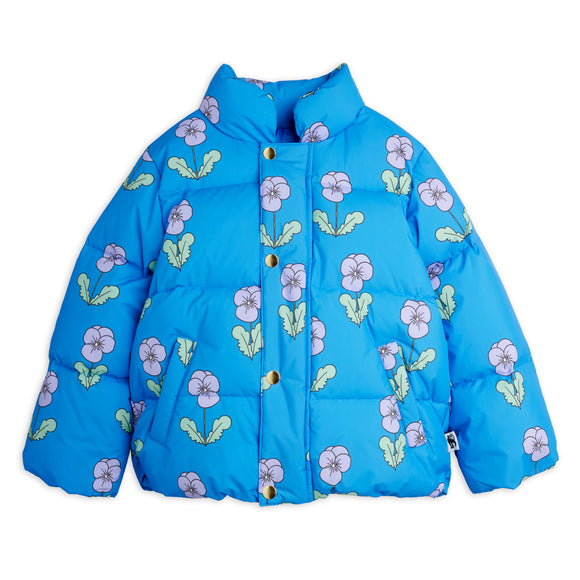 A bright blue puffer jacket with an allover floral print of lavender-purple flowers and light green leaves, featuring a high collar and gold-tone snap buttons.