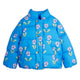 A bright blue puffer jacket with an allover floral print of lavender-purple flowers and light green leaves, featuring a high collar and gold-tone snap buttons.