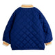 A royal blue quilted bomber jacket shown from the back, featuring diamond-quilted stitching, a cream ribbed collar and cuffs with orange stripes, and an elasticated hem.
