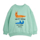 A mint green crewneck sweatshirt featuring a graphic print of an orange velvet worm and a blue pair of velvet worms with text reading 'VELVET WORMS' and 'Observations:'.