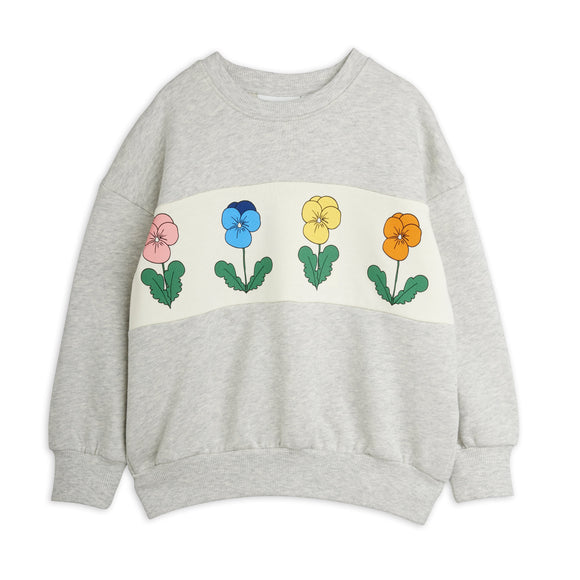 A light gray heather crewneck sweatshirt featuring a horizontal cream-colored stripe across the chest with embroidered pansy flowers in pink, blue, yellow, and orange with green leaves.