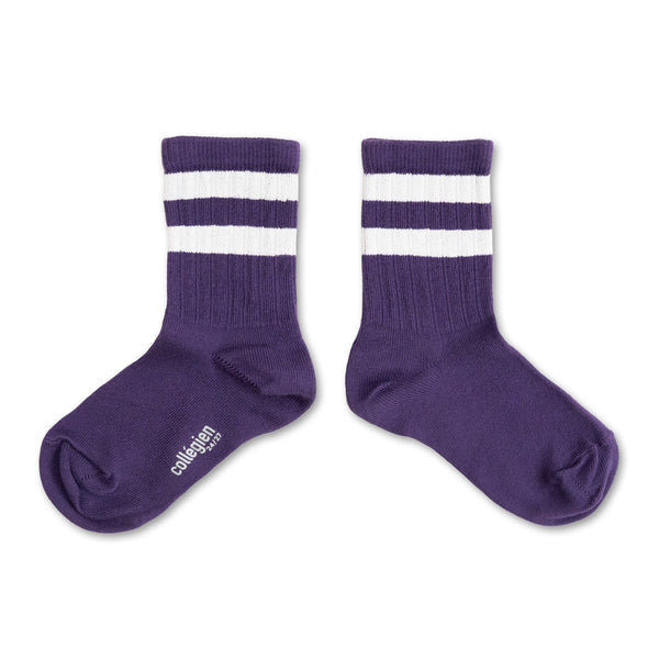 Pair of purple socks with white stripes on a white background