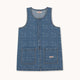 A sleeveless blue denim vest with a subtle tonal monogram pattern, featuring a button-up front and two front patch pockets, shown flat on a light cream background.