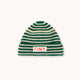 A green and cream striped knit beanie hat with a small white rectangular patch on the front that reads 'TINY' in red letters, shown against a plain off-white background.