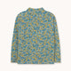 A long-sleeve mock neck shirt with an all-over dense floral print in blue, yellow, and white, displayed flat against a light off-white background.