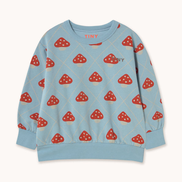 A light blue long-sleeve sweatshirt with a repeating red and white mushroom print, featuring the brand name 'TINY' on the chest and inside the collar, displayed on a clean off-white background.