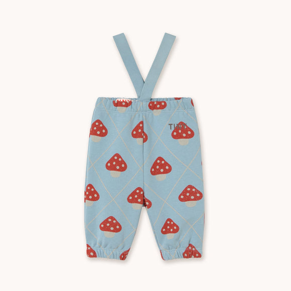 Light blue baby pants with red and white mushroom print and adjustable suspenders, shown flat on a cream background.