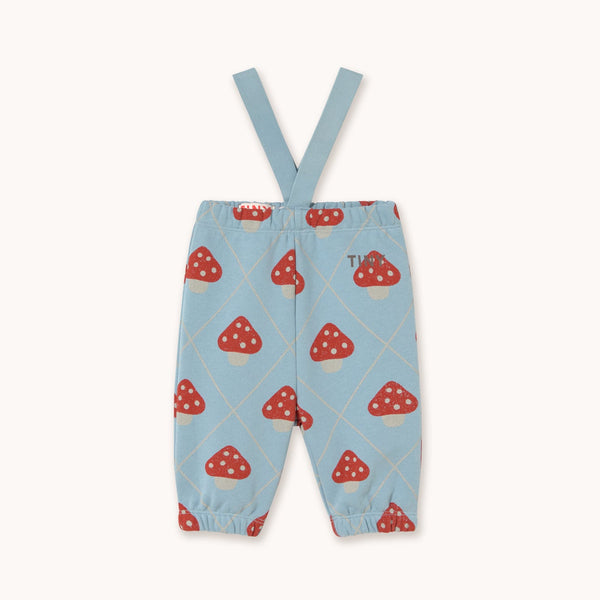 Light blue baby pants with red and white mushroom print and adjustable suspenders, shown flat on a cream background.