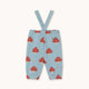 Light blue baby pants with red and white mushroom print and adjustable suspenders, shown flat on a cream background.