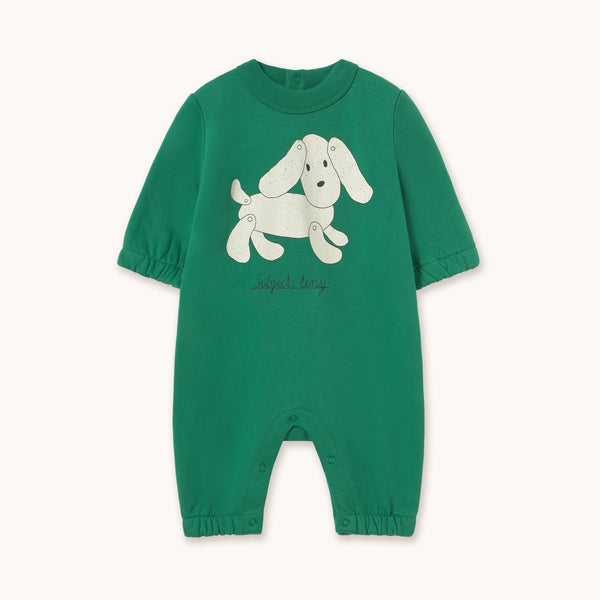 A green short-sleeve baby romper with a white cartoon dog graphic on the chest, displayed flat against a light off-white background.