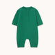 A green short-sleeve baby romper with a buttoned henley neckline, photographed flat against a light cream background.