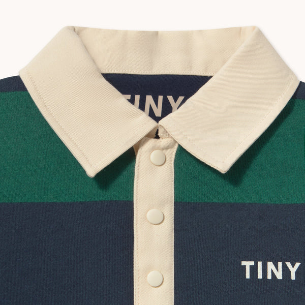 Striped polo shirt with 'TINY' branding on a white background