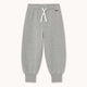 Light heather gray jogger pants with a white drawstring and a small black 'TONY' logo on the upper right hip, displayed flat against a light off-white background.