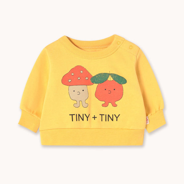 Yellow sweatshirt with cartoon characters and 'TINY + TINY' text on a white background