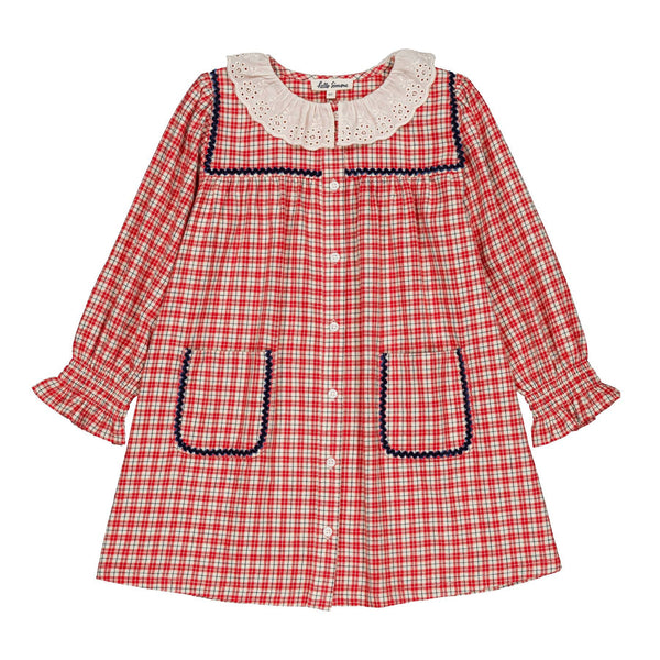 A red and white gingham long-sleeve dress for toddlers, featuring a cream-colored lace Peter Pan collar with dark blue trim, decorative dark blue trim around the front pockets, and a button-up front.