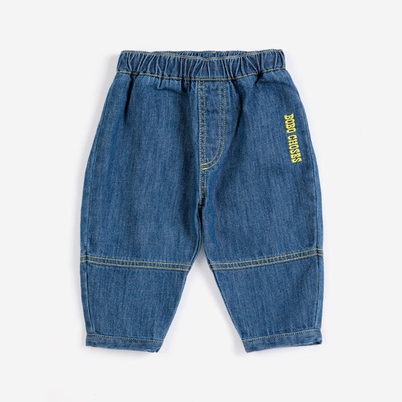 Blue denim pants with a brand logo on a white background