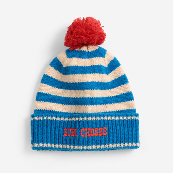 Striped beanie with red pom-pom and 'BUBU CHoses' text on a white background