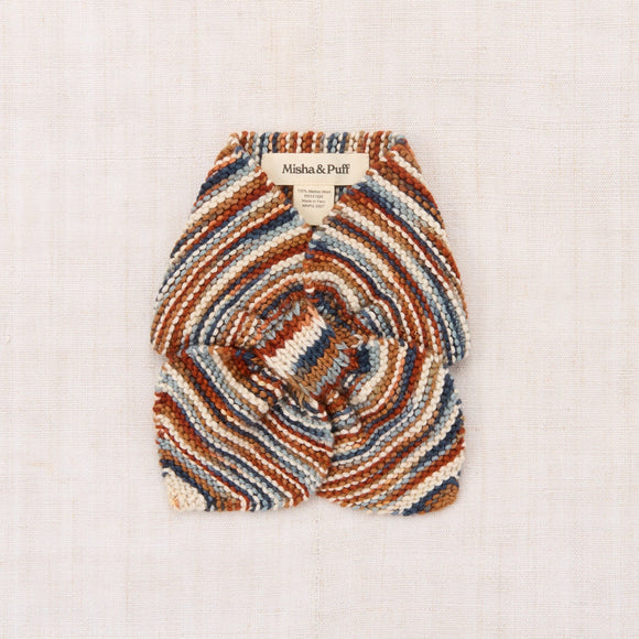 Multicolored patterned hot water bottle cover on a white background