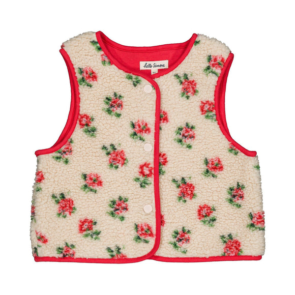 A sleeveless cream sherpa vest with a red trim and a red and green floral pattern, featuring a snap-button front and a visible 'Life is Sweet' brand label.