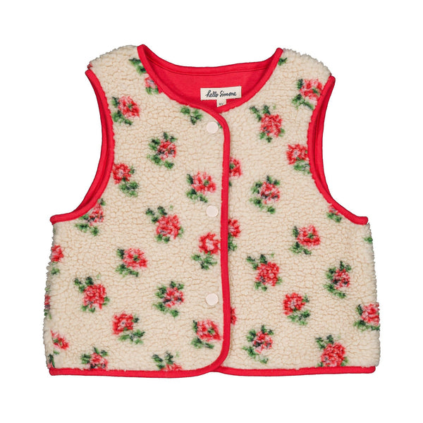 A sleeveless cream sherpa vest with a red trim and a red and green floral pattern, featuring a snap-button front and a visible 'Life is Sweet' brand label.