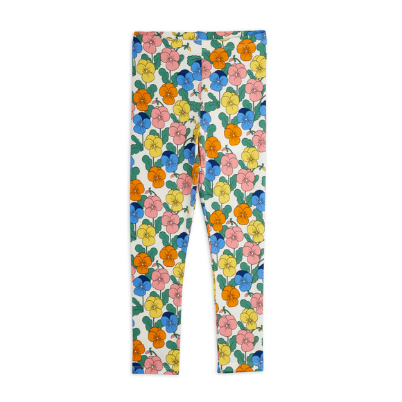 A pair of children's leggings with a colorful floral print on a white background, featuring pink, yellow, orange, and blue flowers with green leaves.