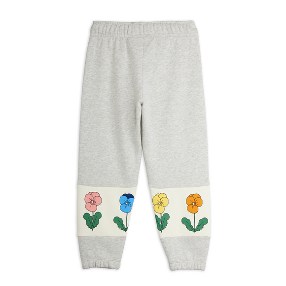 Light heather gray sweatpants with a cream-colored band near the ankles featuring embroidered pansy flowers in pink, blue, yellow, and orange.