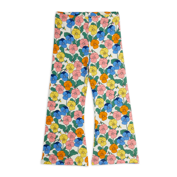 A pair of wide-leg pants featuring a colorful floral print on a white base, with blue, pink, yellow, and orange flowers and green leaves.