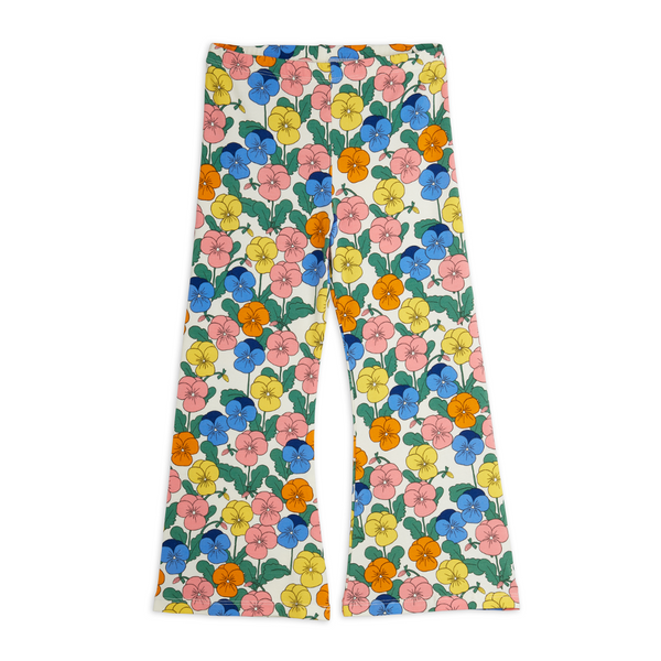 A pair of wide-leg pants featuring a colorful floral print on a white base, with blue, pink, yellow, and orange flowers and green leaves.
