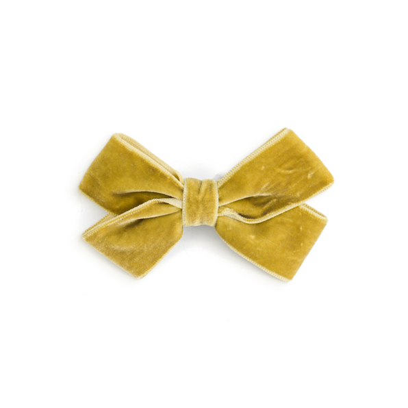 A small velvet bow accessory in a mustard yellow color, centered on a plain white background.