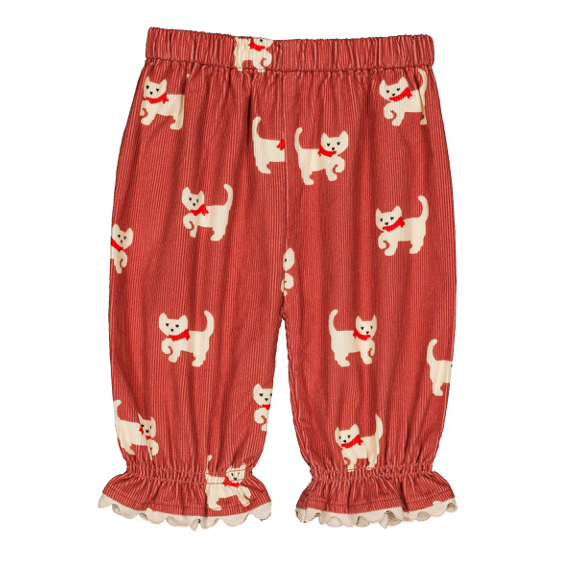 A pair of toddler's elastic-waist pants in rust red, featuring an all-over print of cream-colored cats wearing red bows, finished with ruffled trim at the ankles.