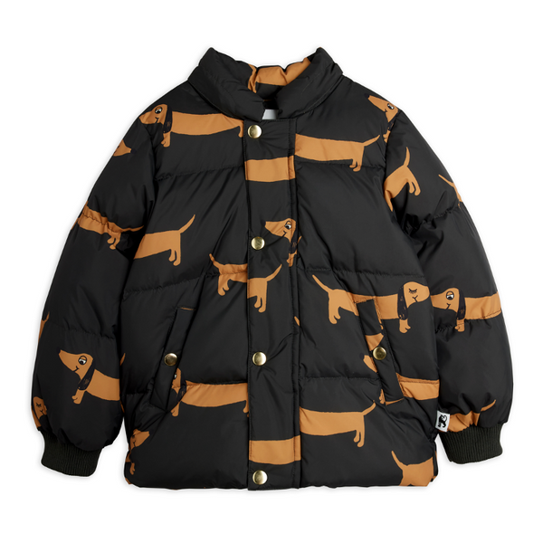 A black puffer jacket with an all-over tan dachshund dog print, featuring a snap-button front and a hood, shown against a plain white background.