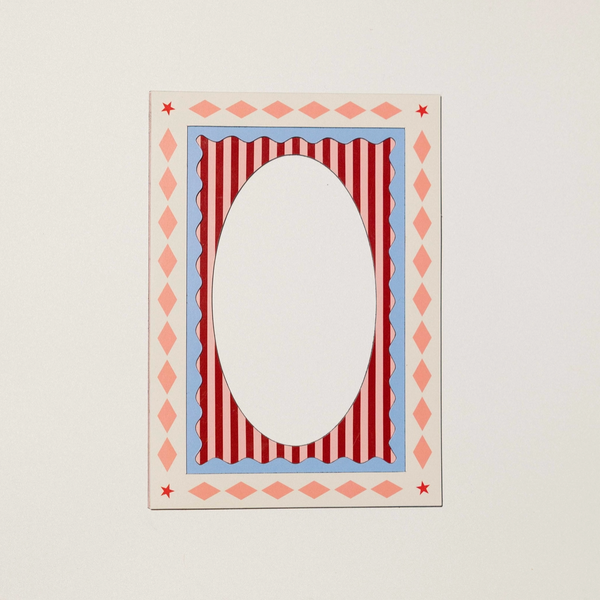A decorative rectangular card or frame with a large oval cutout in the center, featuring a red and white striped inner design, a light blue scalloped border, and a pink diamond pattern around the edges, shown against a plain off-white background.
