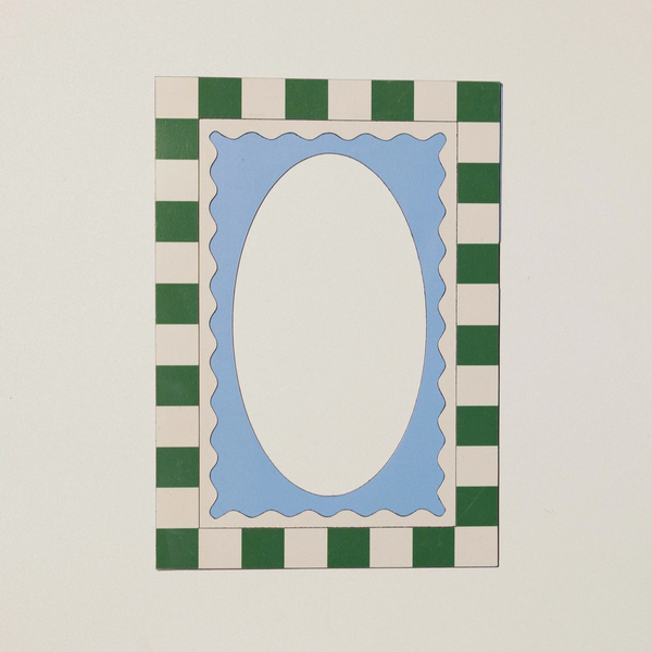 A square decorative frame or mat design with a green and cream checkered border surrounding a light blue scalloped inner border and a large cream oval center, shown on a plain light background.
