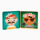 Two square metal lunch boxes shown side by side on a light gray background. The left box has a teal background with a stylized cartoon man wearing a white hat and mustache.