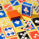 A deck of playing cards labeled 'READ 'EM AND WEEP' with an orange card box and blue/orange card box standing on a yellow surface surrounded by scattered cards in blue, red, black, and white.