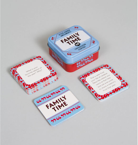 A boxed card game set labeled 'Family Time' with a blue and red metal tin and several matching cards arranged on a light gray background.