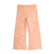 A pair of wide-leg children's pants in a peachy pink color, featuring an all-over white daisy pattern with small red centers, shown flat on a white background.