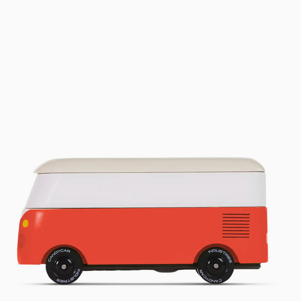A retro-style toy van with a two-tone design, featuring a white upper section and a coral-red lower section, with black wheels and a light beige roof, shown against a plain white background.