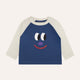 Children's blue and white shirt with a face design on a white background