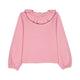A pink long-sleeve blouse with a ruffled collar and gathered cuffs, shown flat against a plain white background.